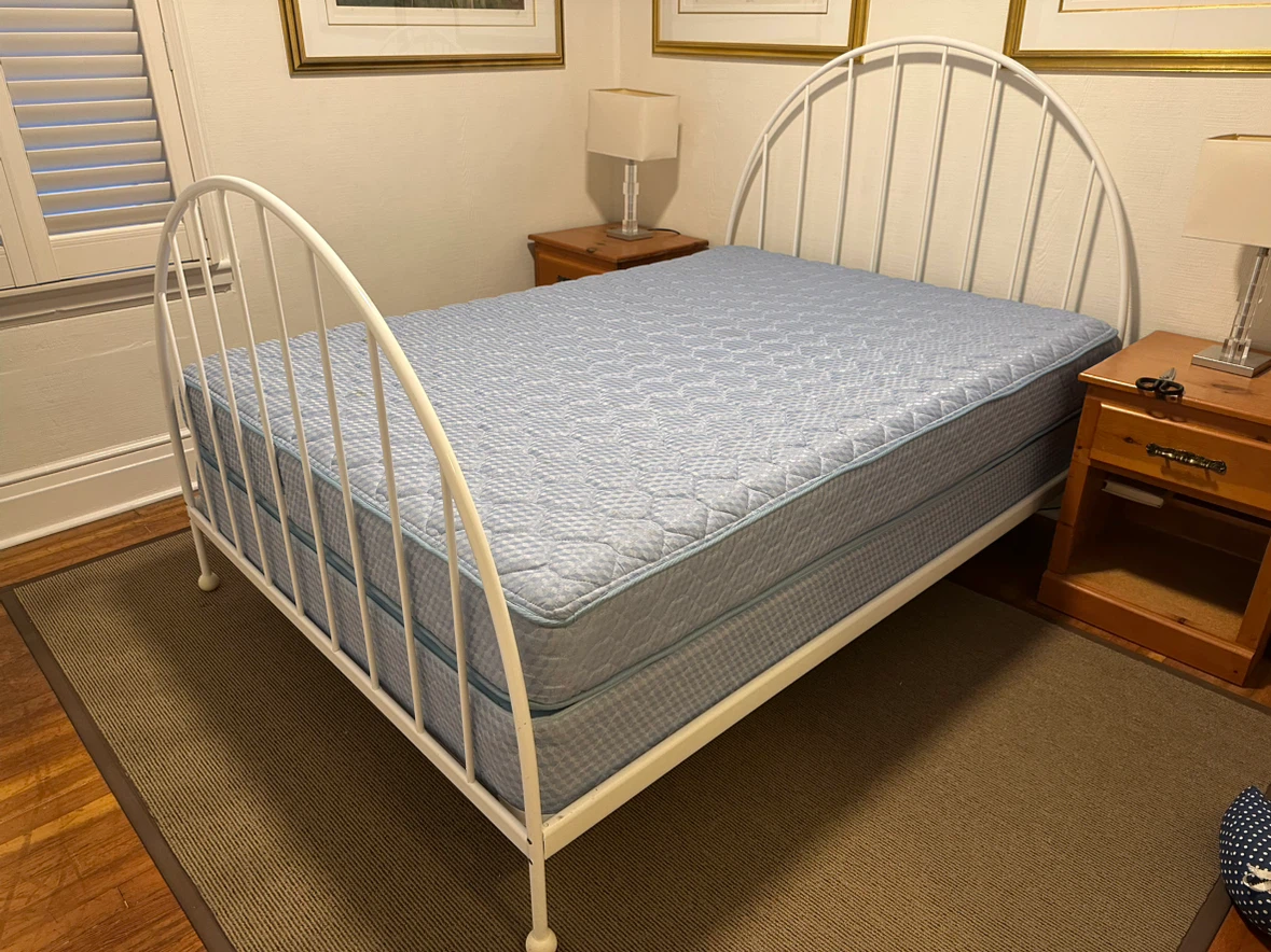 Double bed frame, mattress and box spring.