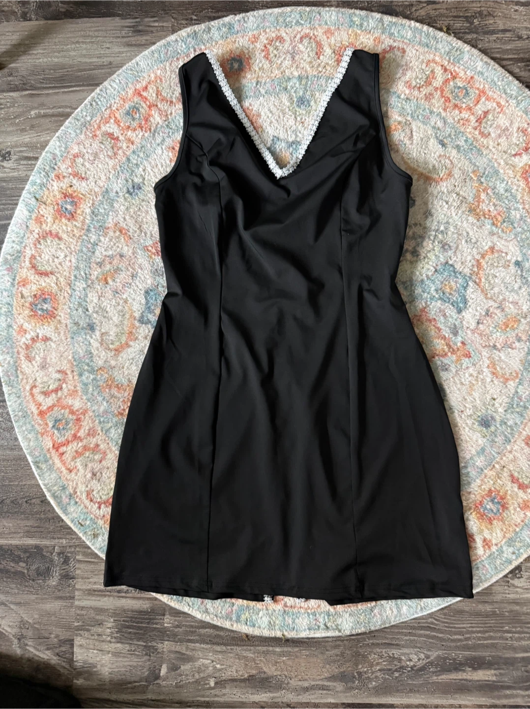 Black sleeveless mini dress with lace trim