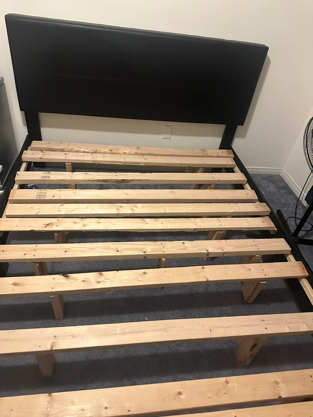 Black upholstered headboard and bed frame