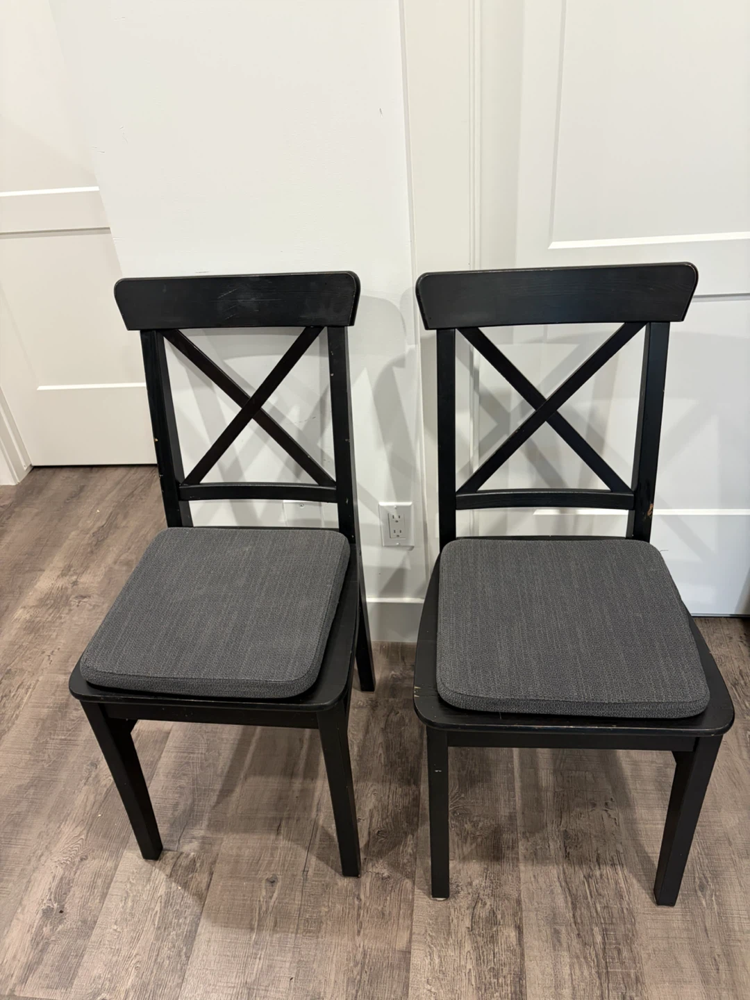 pair of IKEA black chairs wooden