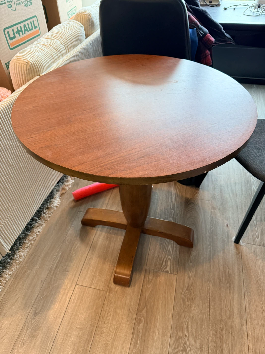 Round wooden pedestal dining table