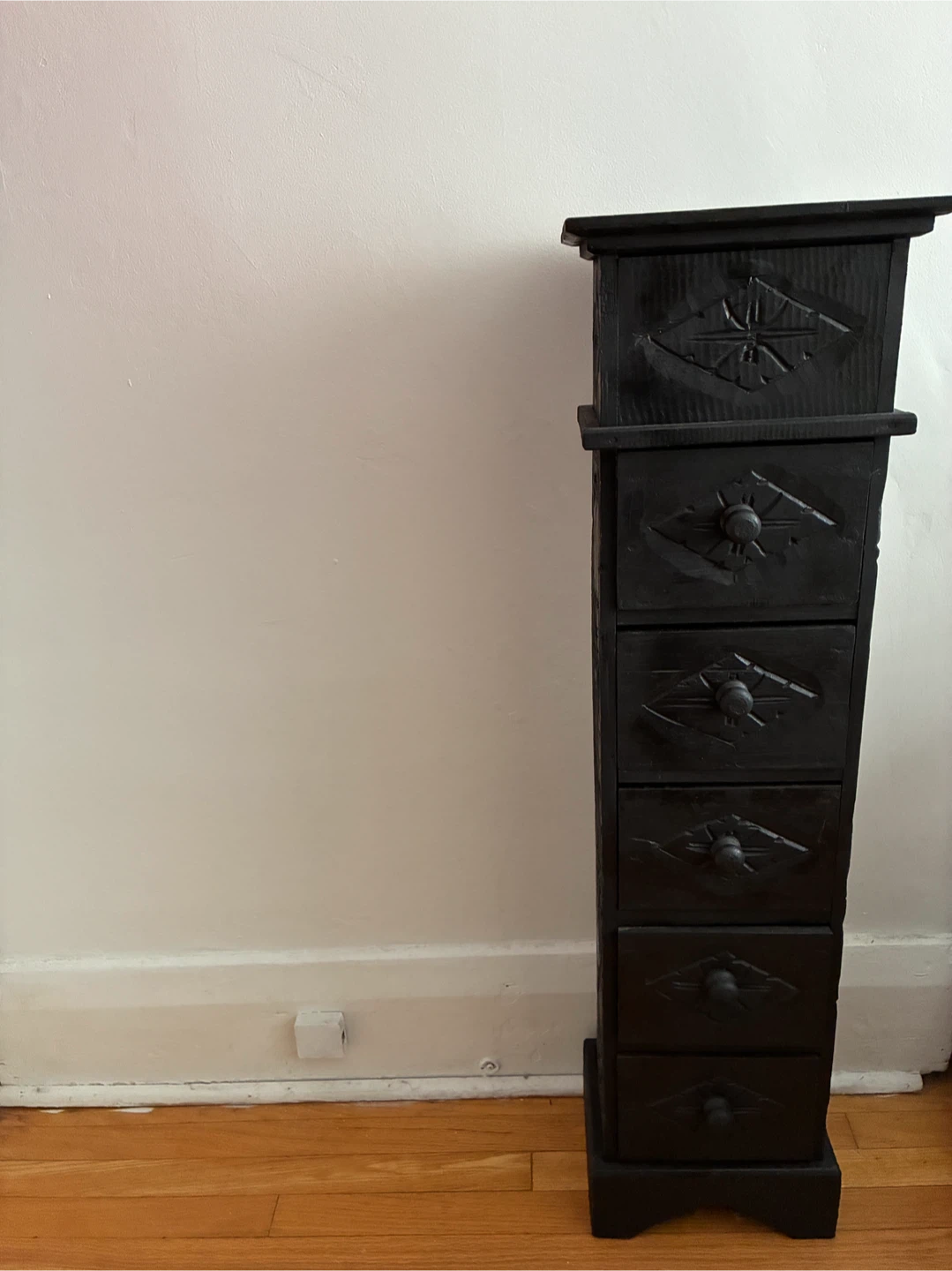 Black wooden storage chest with drawers