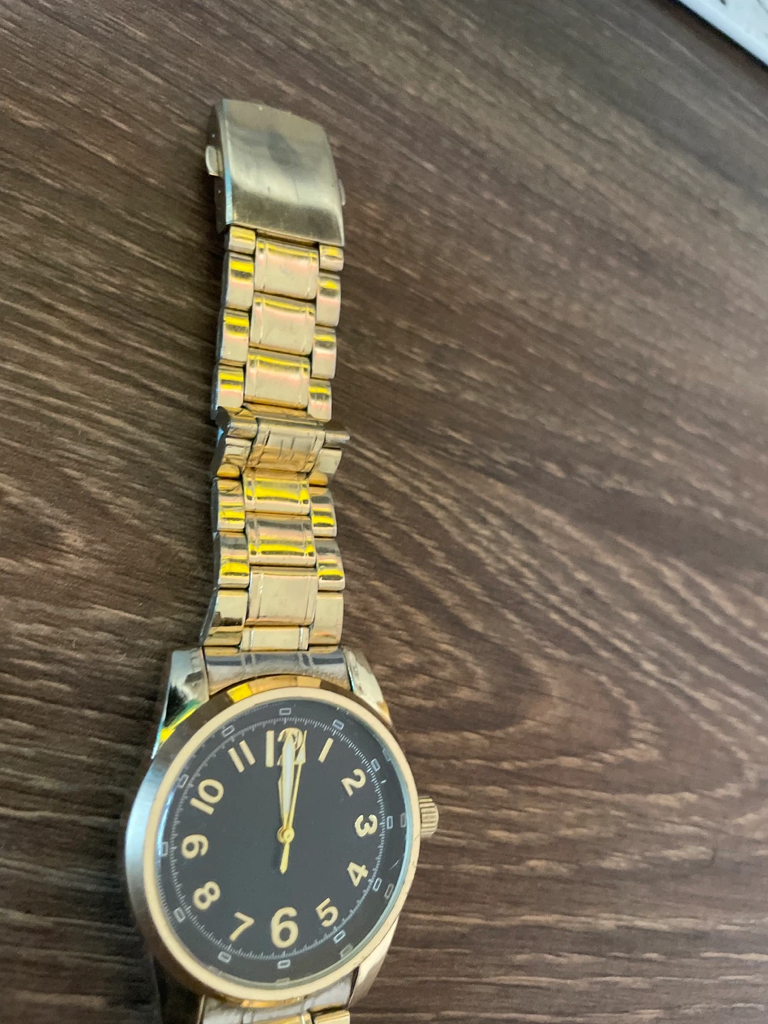 Gold-tone wristwatch with black dial