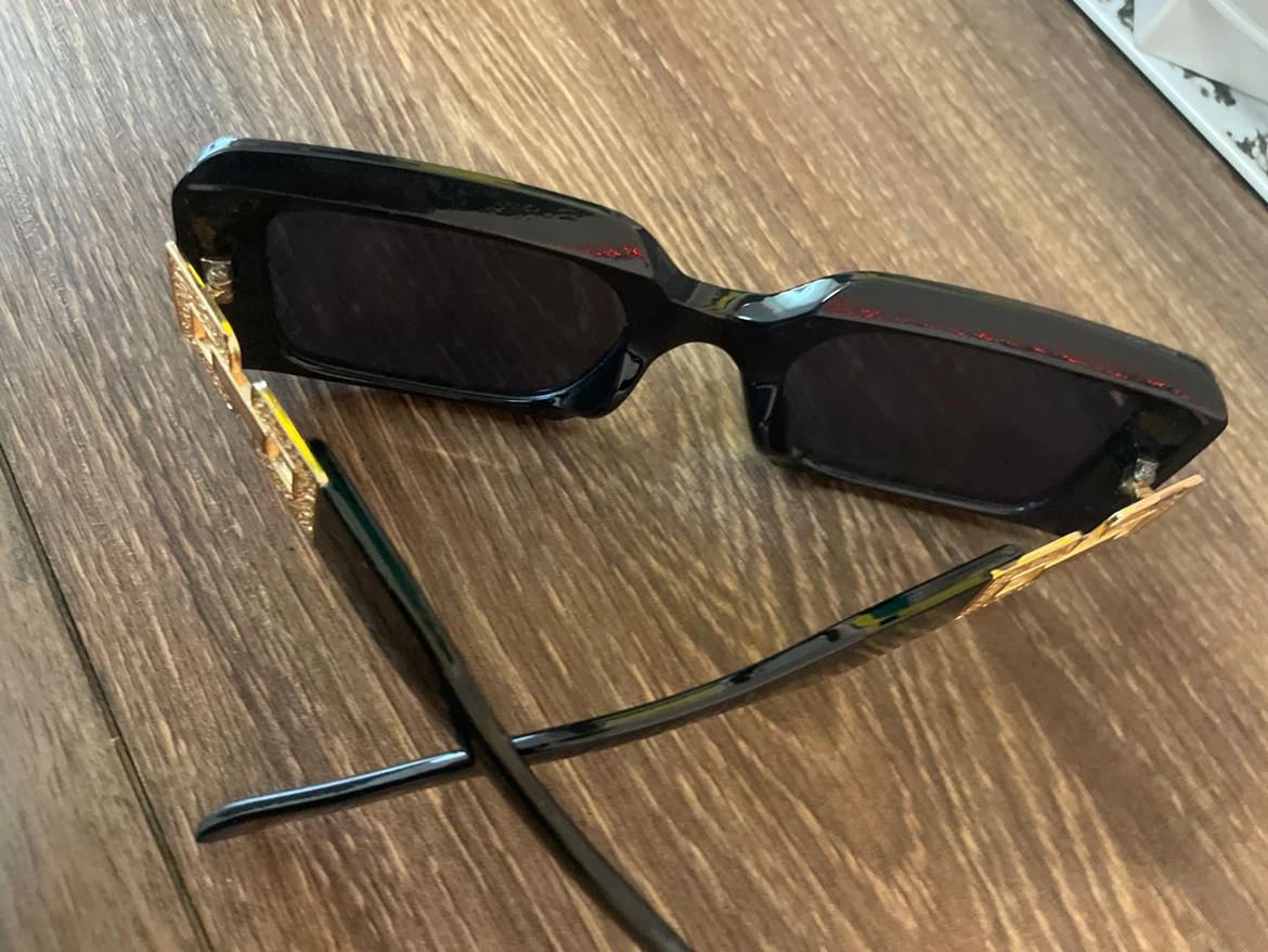 Black rectangular sunglasses with gold-tone accents