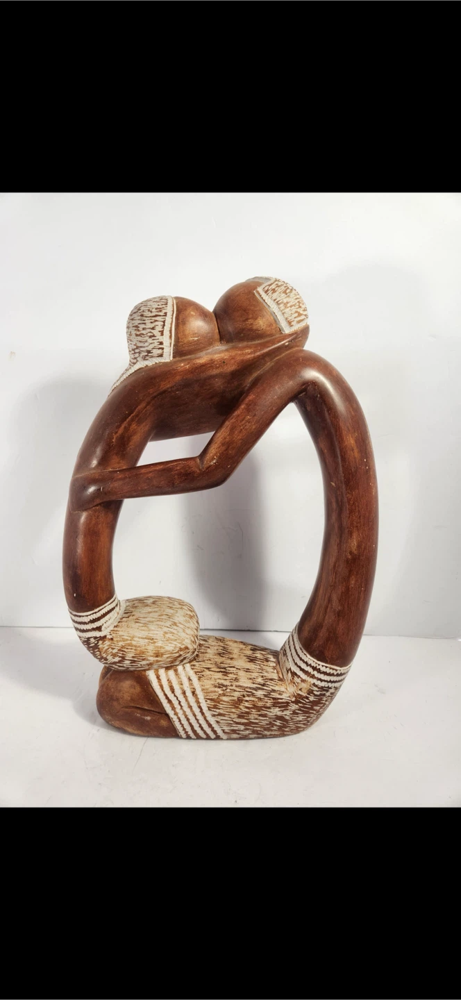 Hand-carved wooden embracing couple sculpture