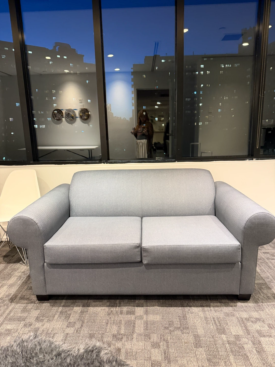 Light grey two-seater pull out couch