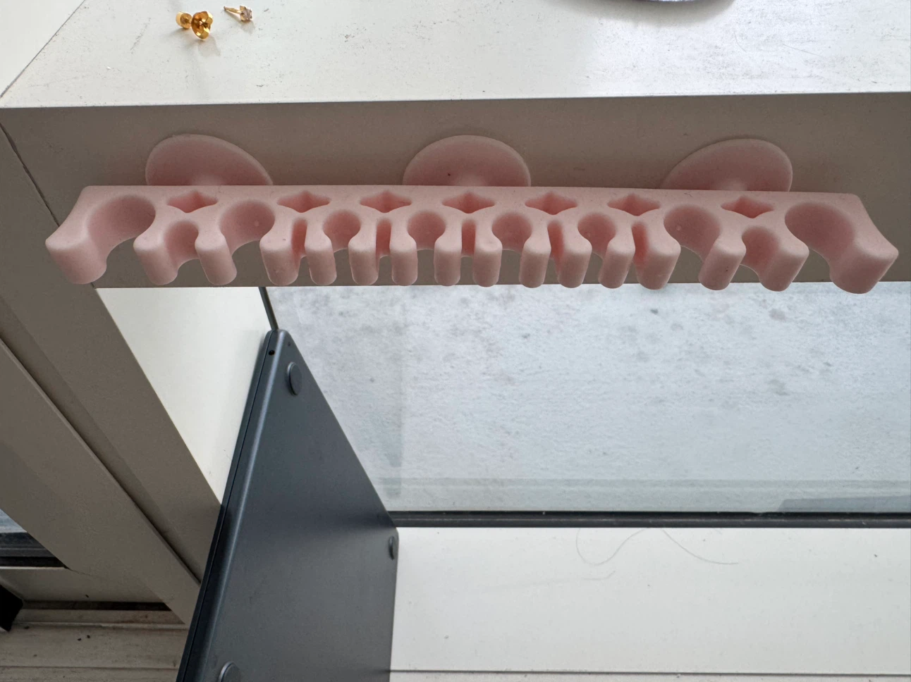 Pink wall-mounted makeup brush holder