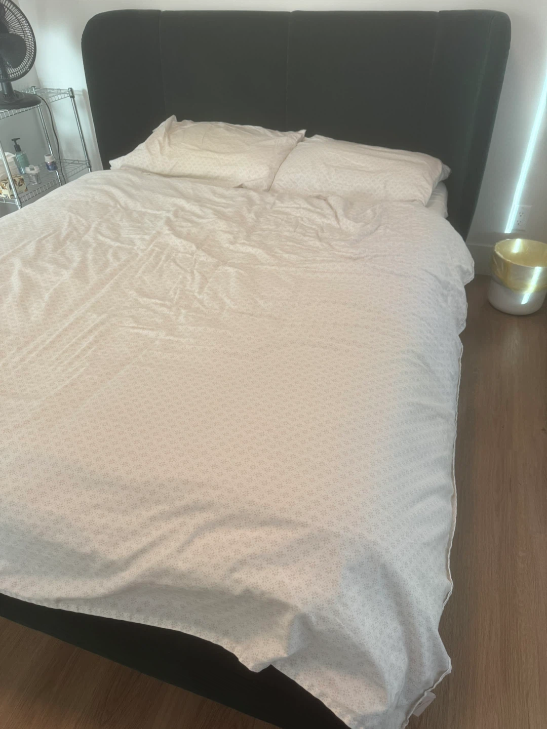 Black upholstered queen-size bed frame with mattress