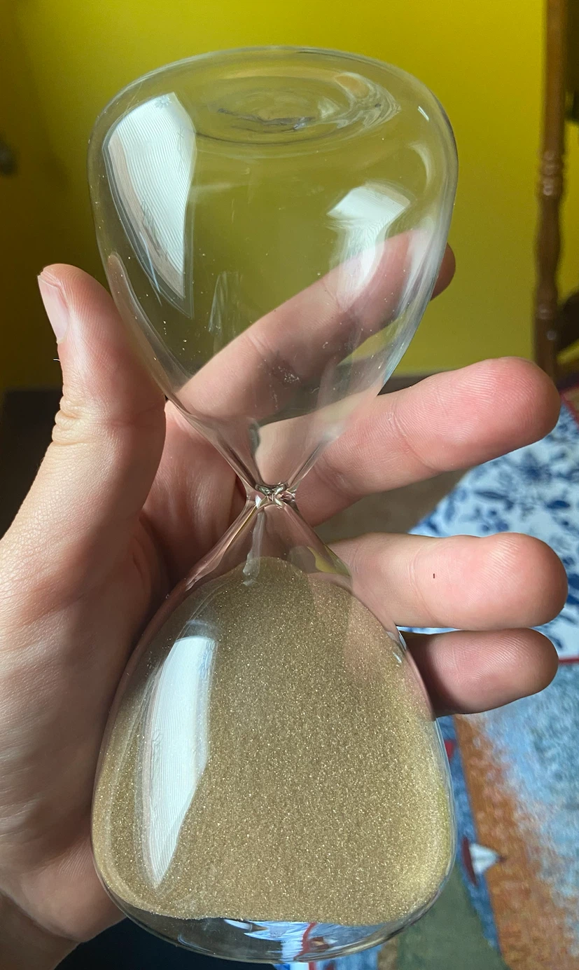 Glass hourglass with brownish sand