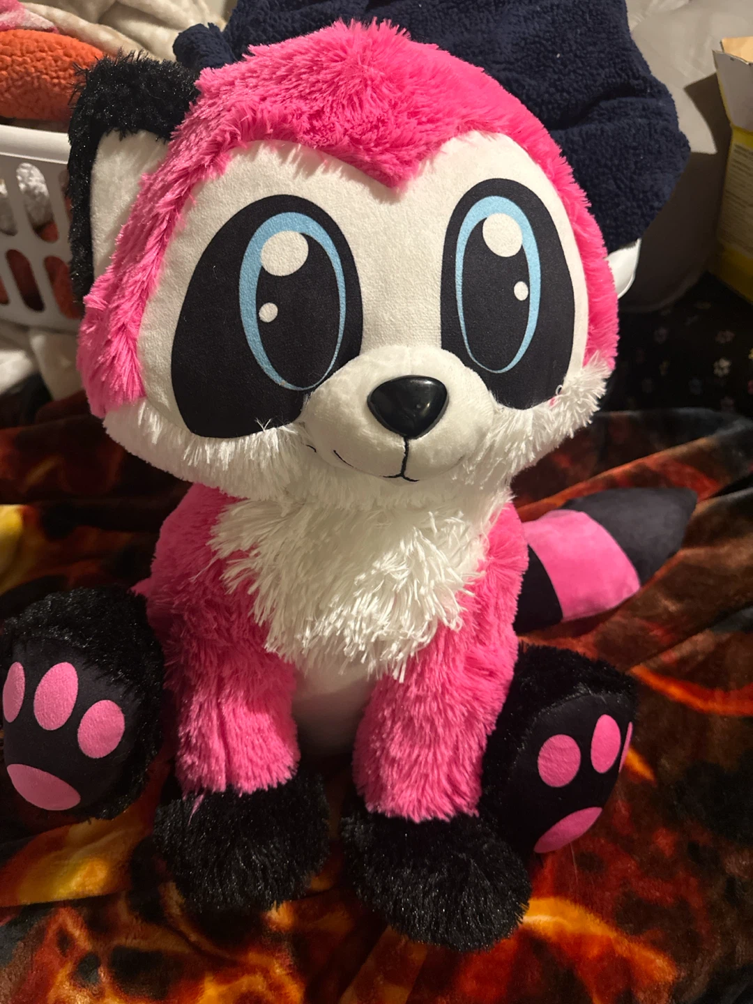 Pink and black raccoon plush toy