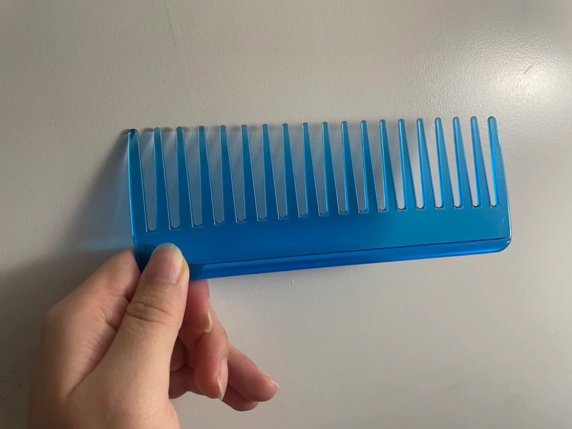 Blue plastic wide-tooth comb