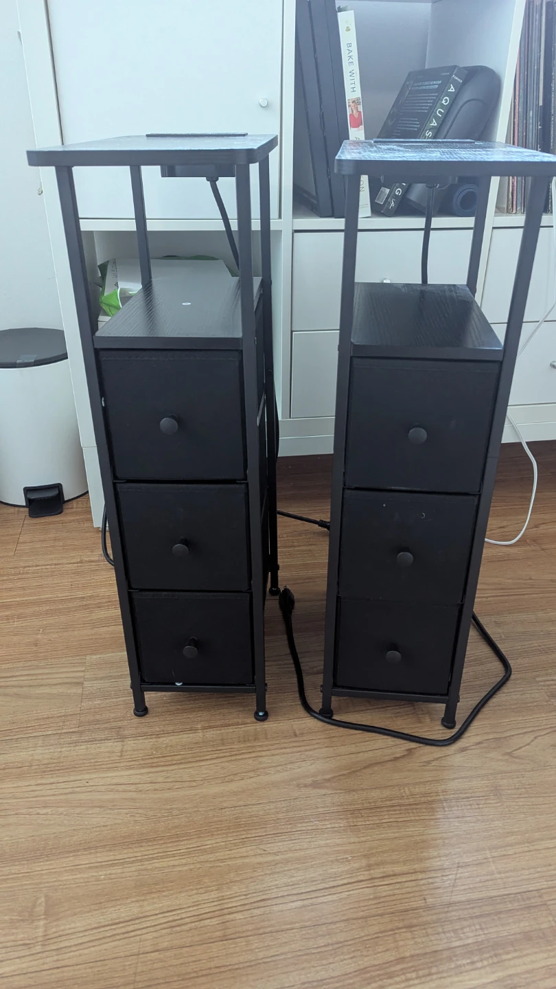 Pair of narrow black nightstands with charging stations