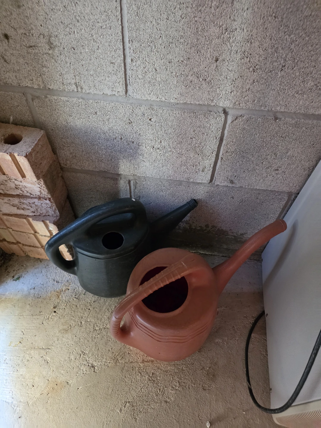 Two plastic watering cans