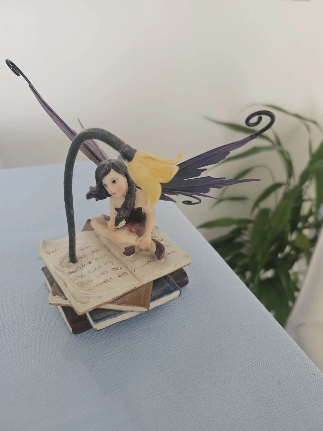 Fairy Figurine Sitting on Books with light.