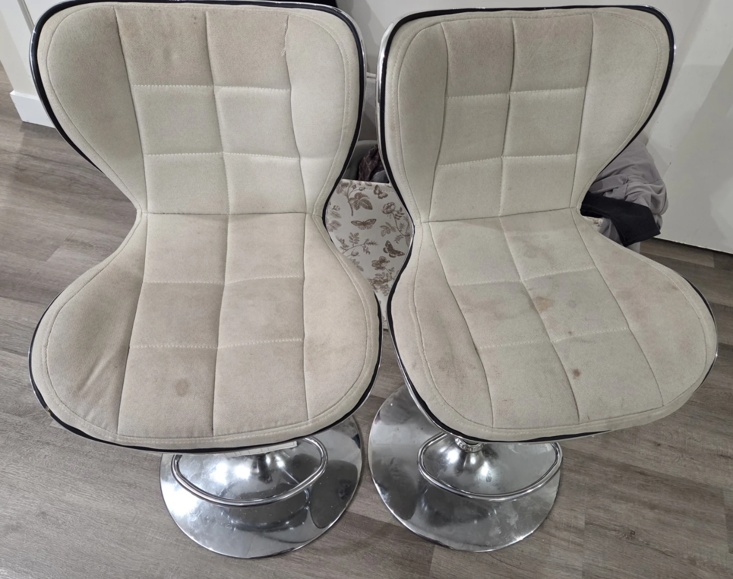 Two cream upholstered bar stools