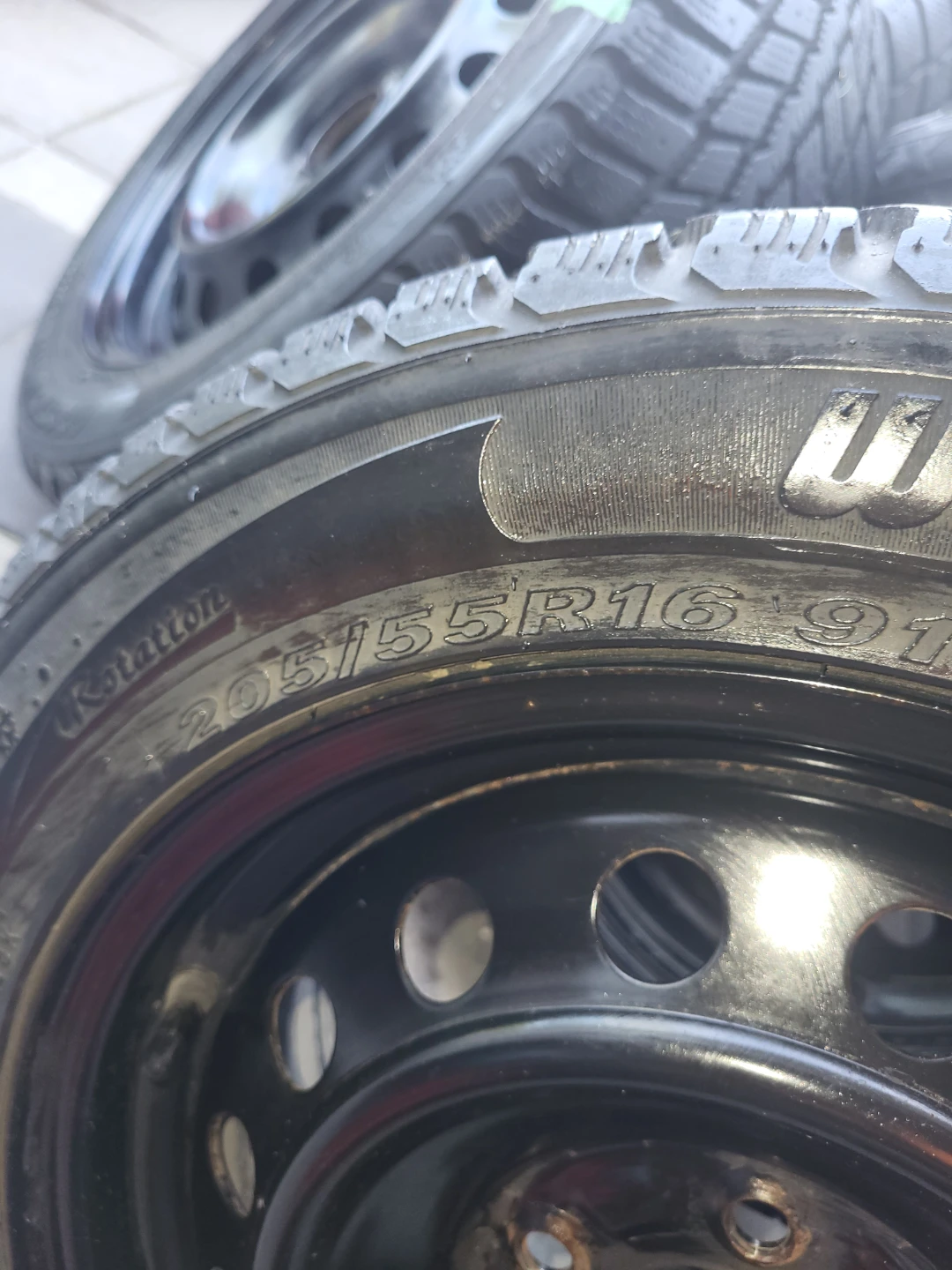 Set of four winter tires mounted on black steel
