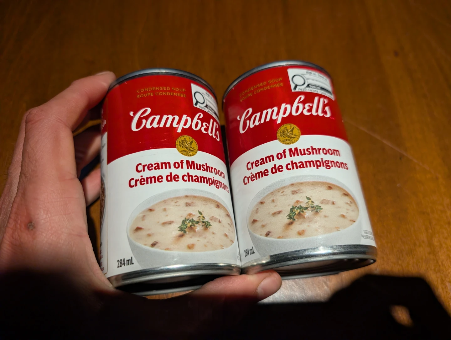 Two cans of Campbell's Cream of Mushroom soup
