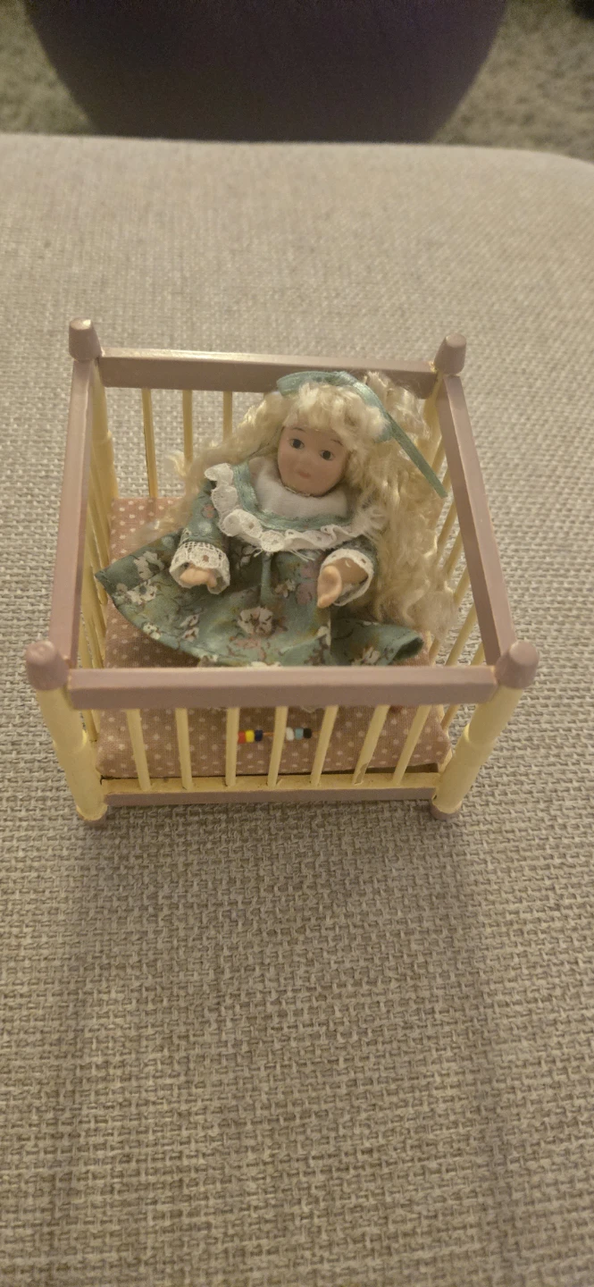 Miniature Porcelain Doll in Wooden Crib