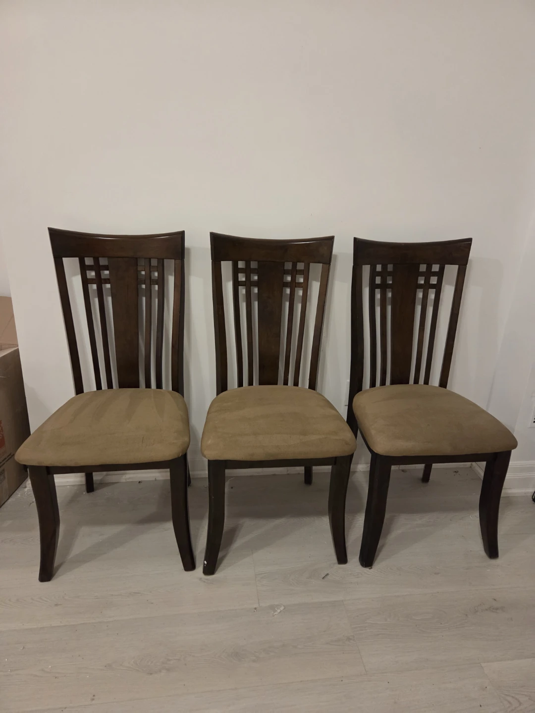 Three dark wood dining chairs