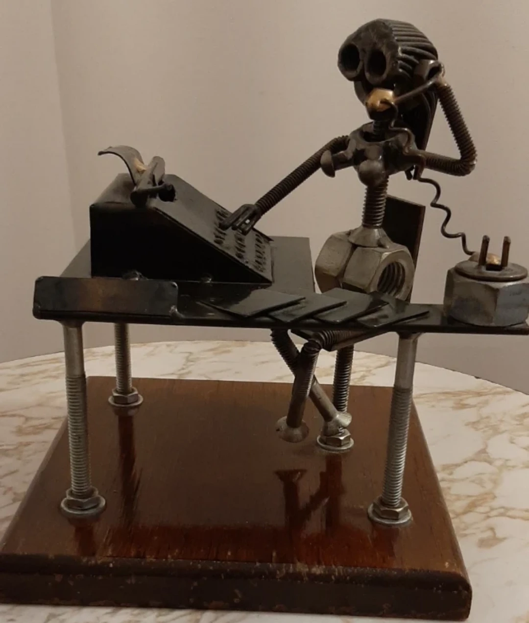 Metal art sculpture of an office worker at a desk