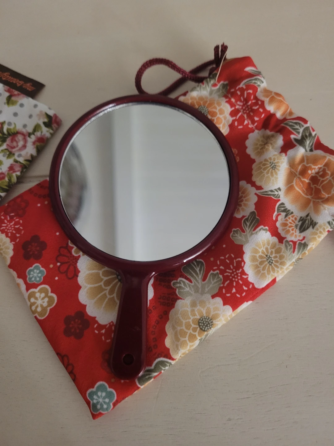 Floral pattern hand mirror with drawstring pouch