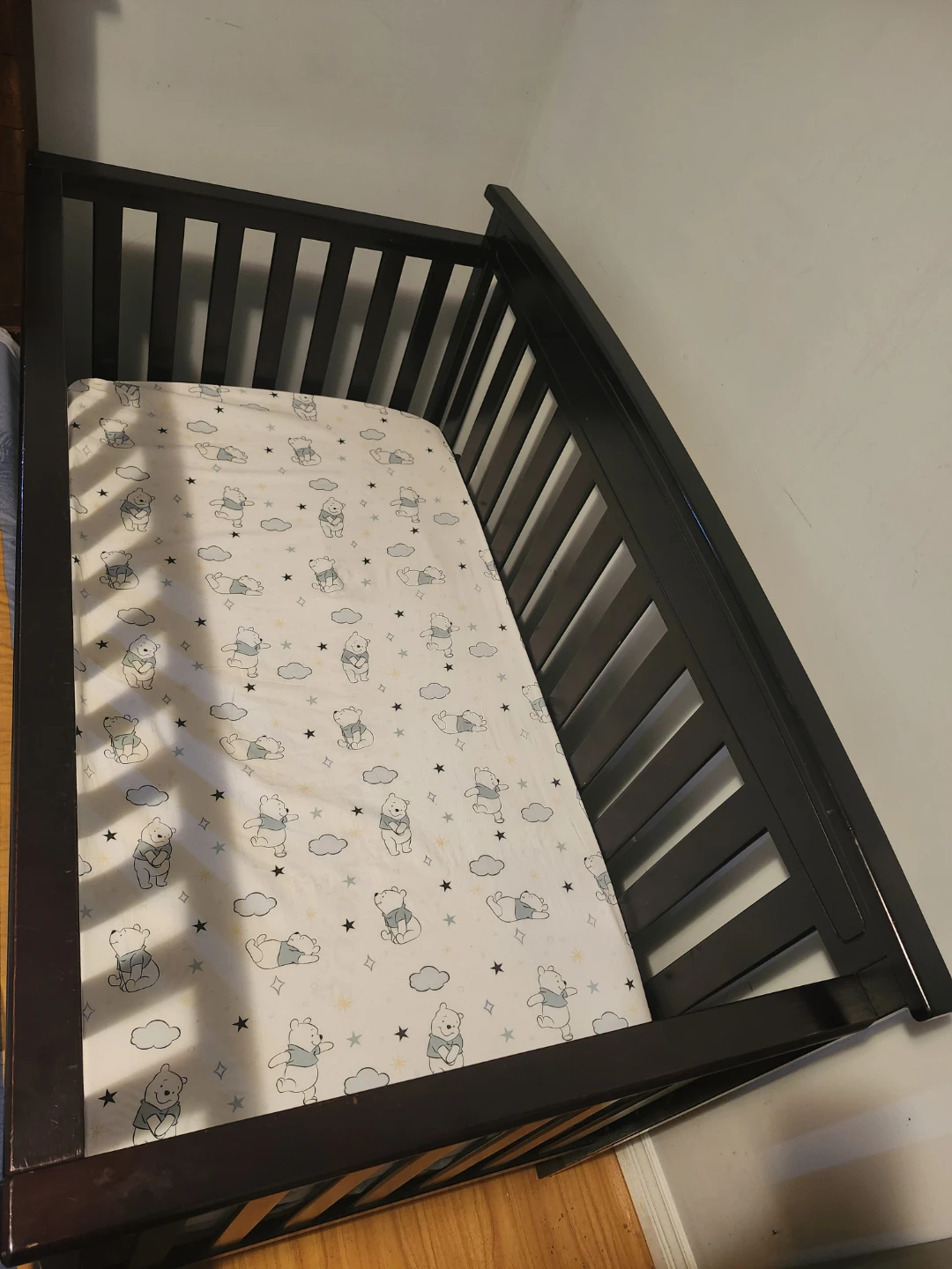 Dark Brown Crib with Winnie the Pooh Sheet