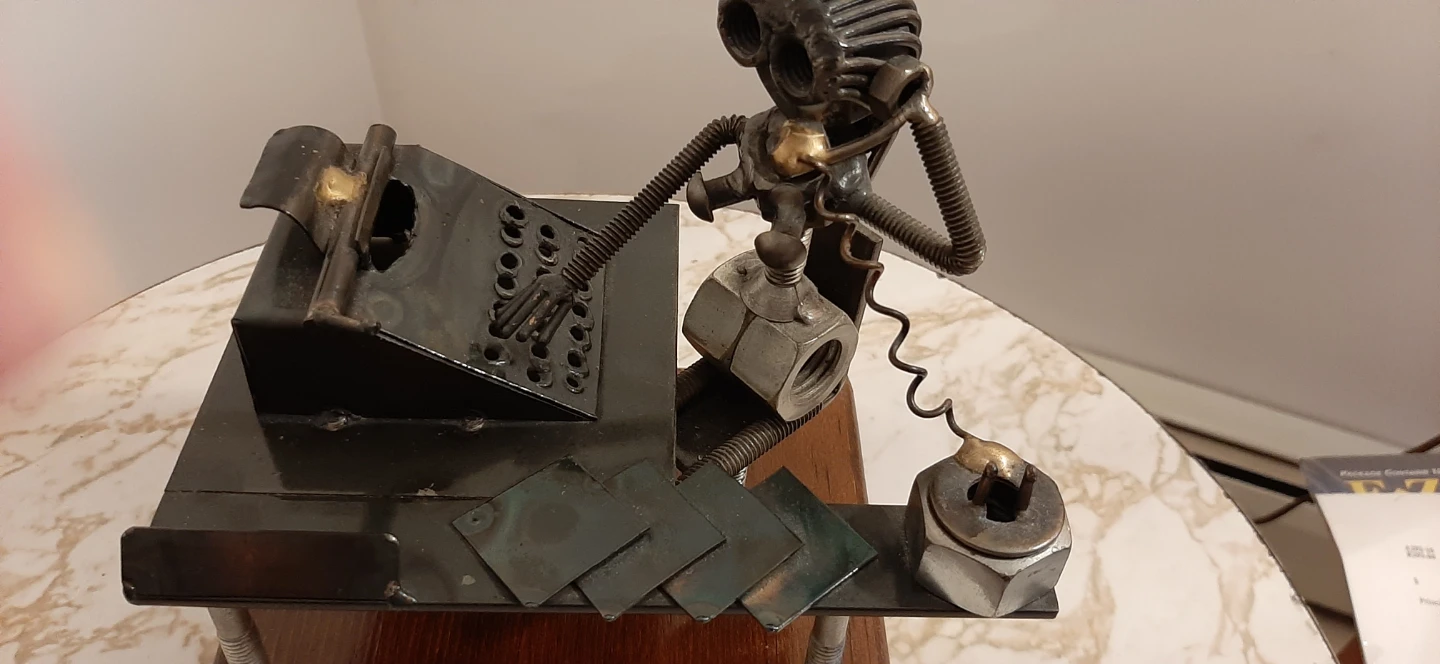 Metal art sculpture of an office worker at a desk - photo 2