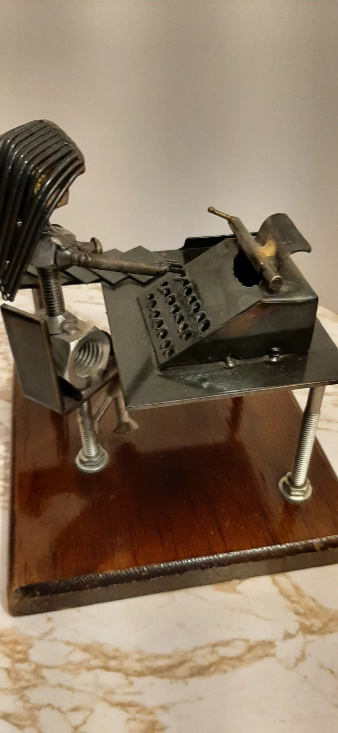 Metal art sculpture of an office worker at a desk - photo 4