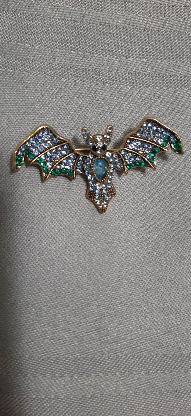 bat-shaped brooch with Blue & green stones