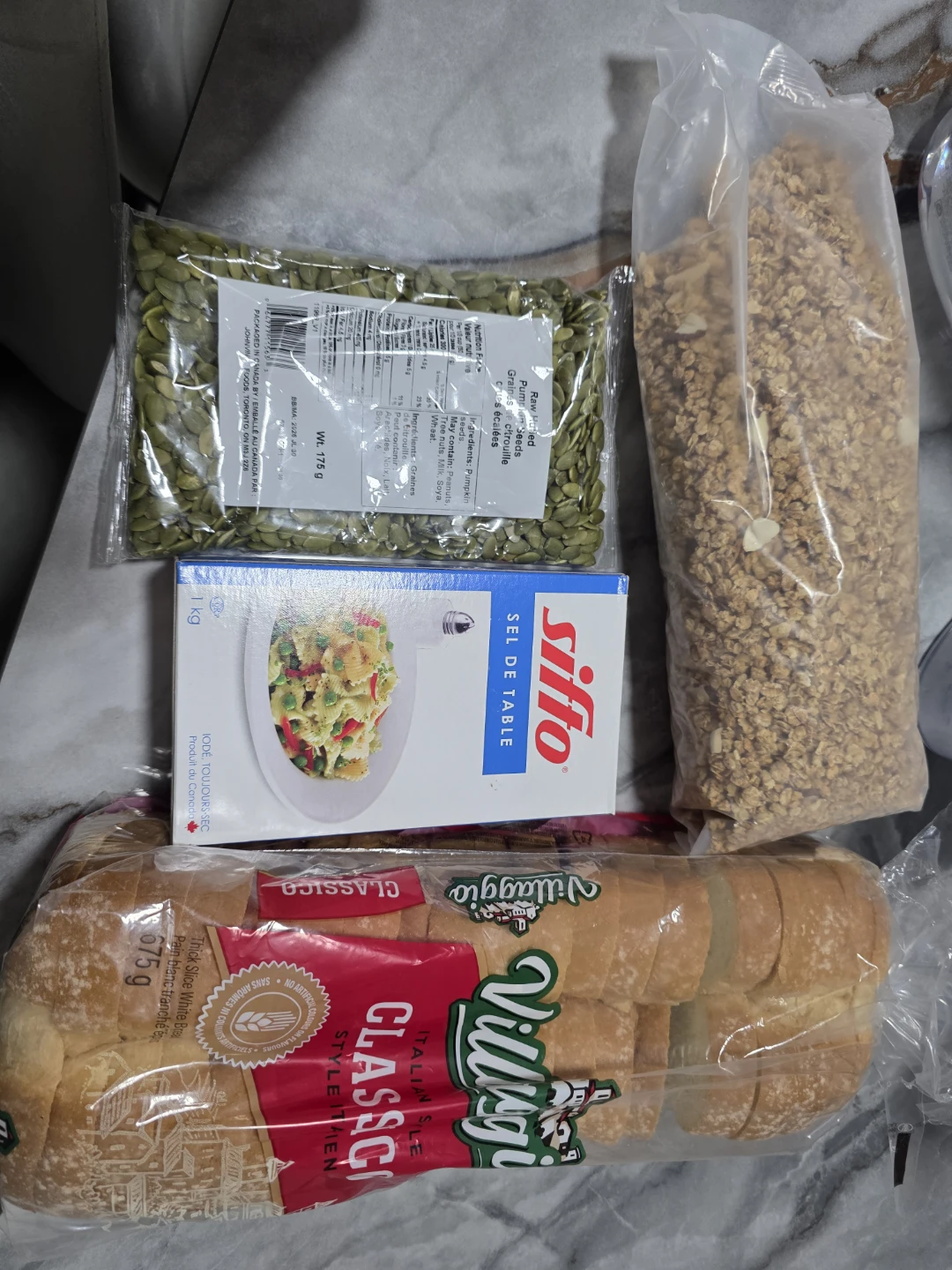 Assorted Food Items: Bread, Salt, Seeds, and Granola