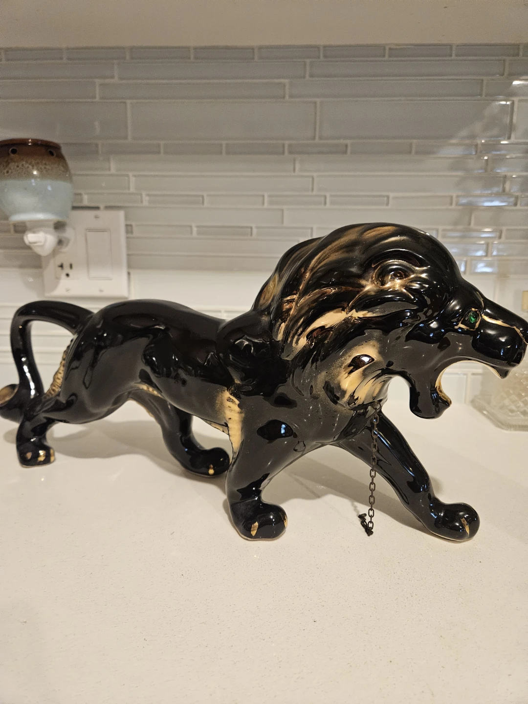 Striking black-and-gold ceramic lion