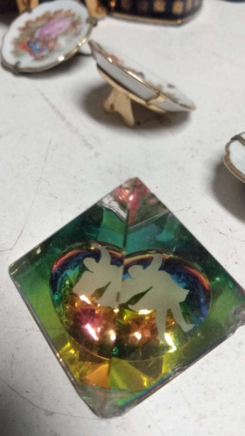 Iridescent glass pyramid figurine with etched dancers