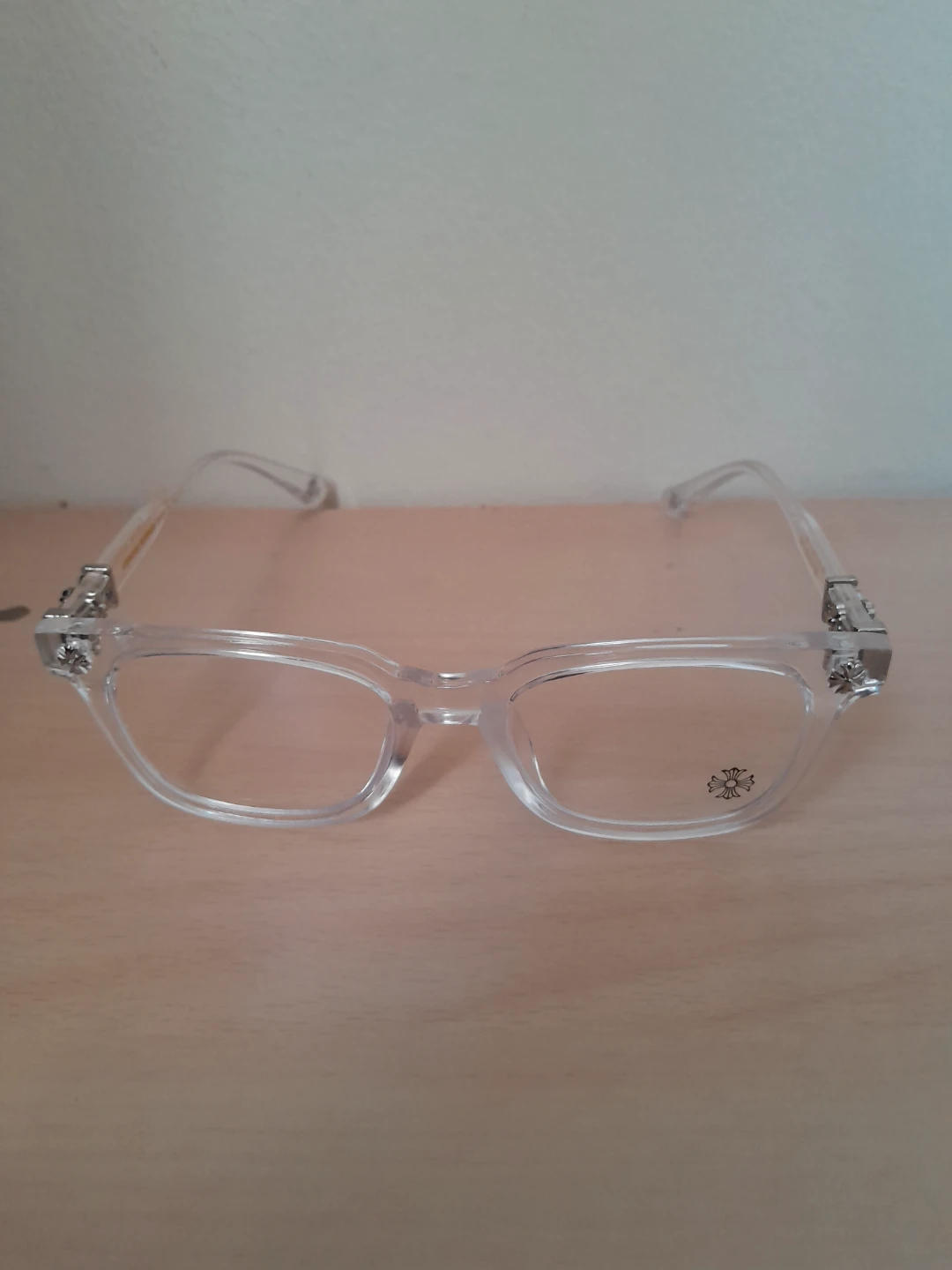 Clear and silver Chrome hearts glasses.