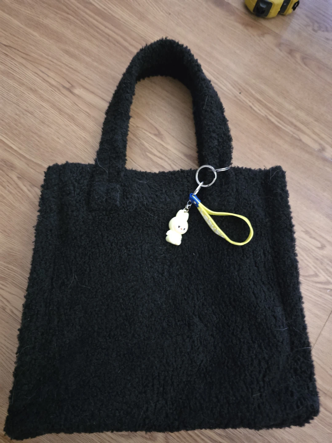 Black fuzzy tote bag with charm