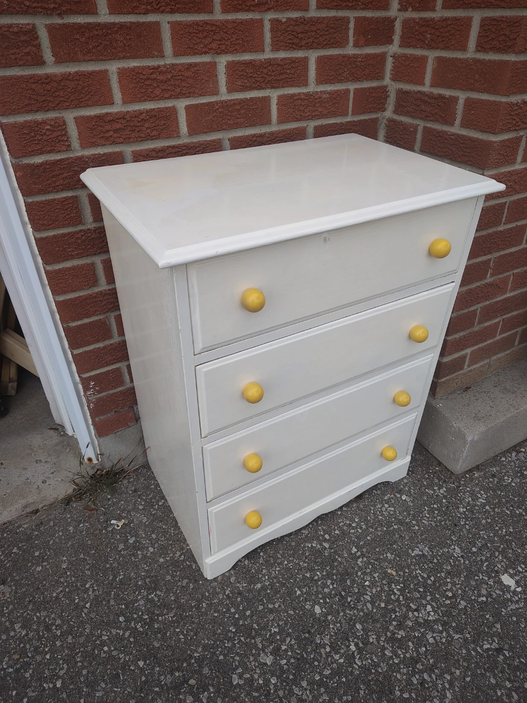 White Four-Drawer Dresser with Yellow Knobs