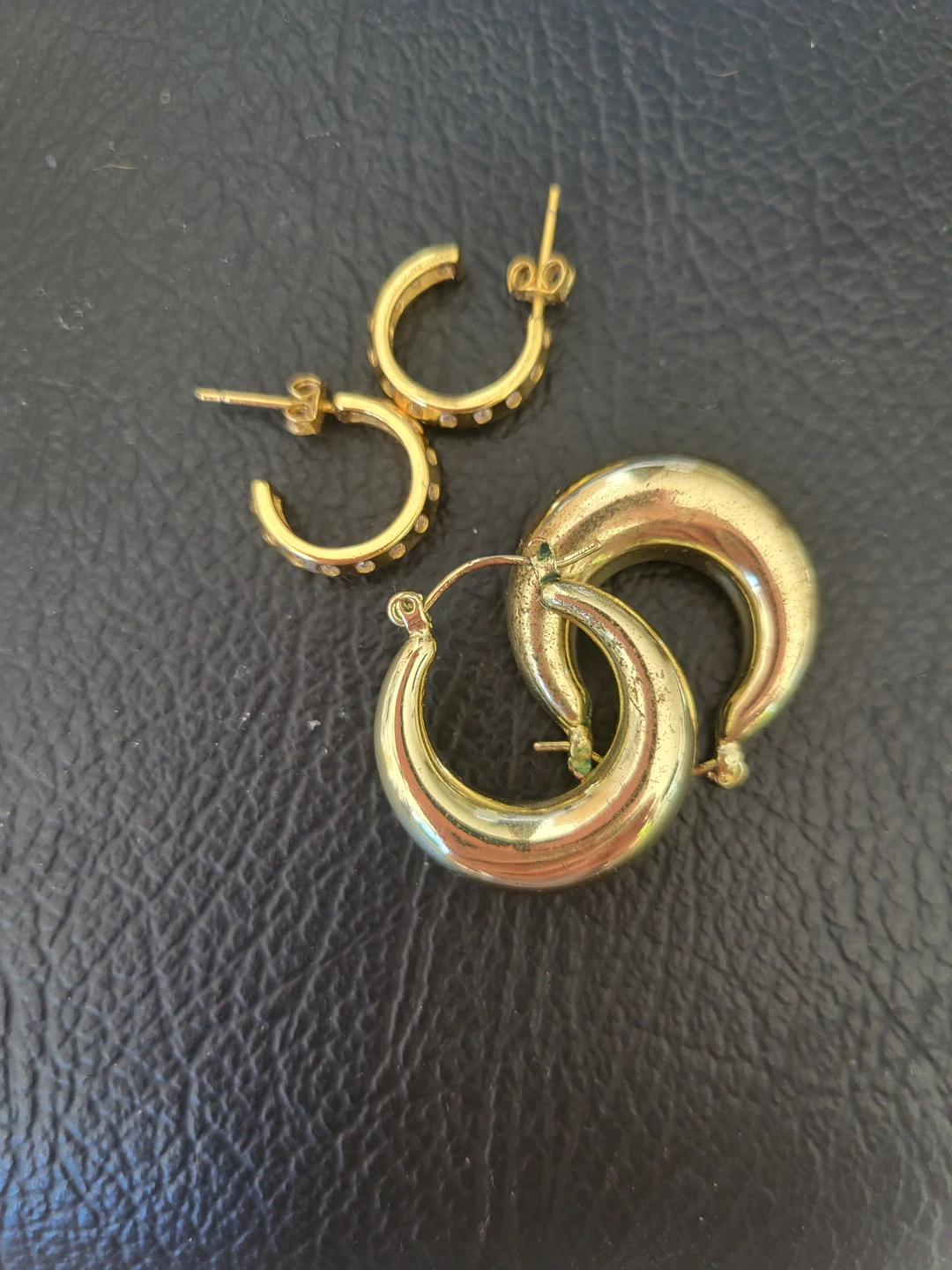 Two pairs of gold tone hoop earrings