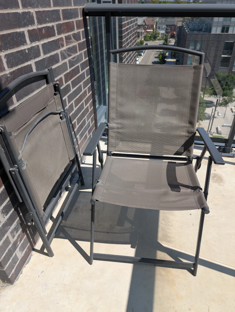Two Grey Folding Patio Chairs