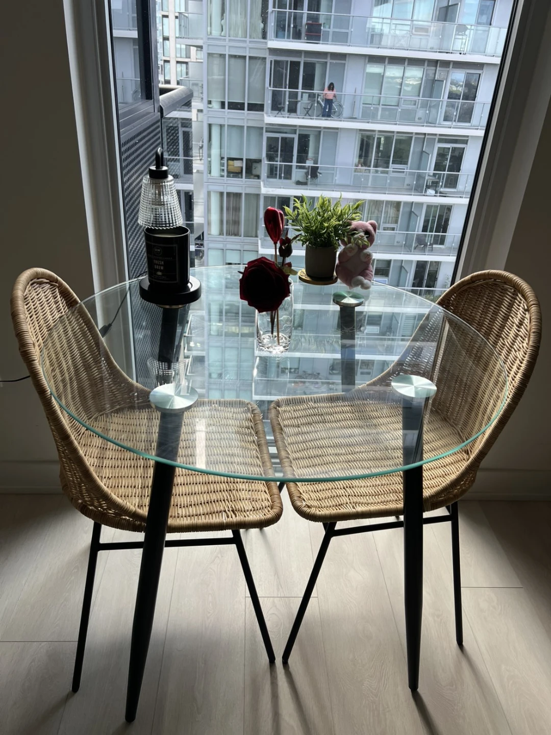 Glass Dining Table and Two Wicker Chairs