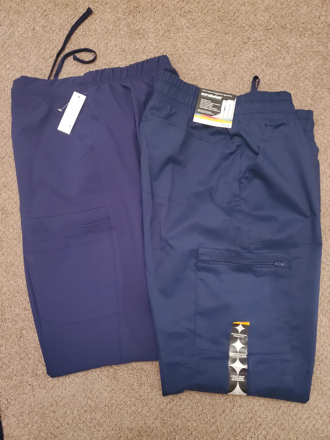Brand new. Two pairs of Scrubstar scrub tops and pants