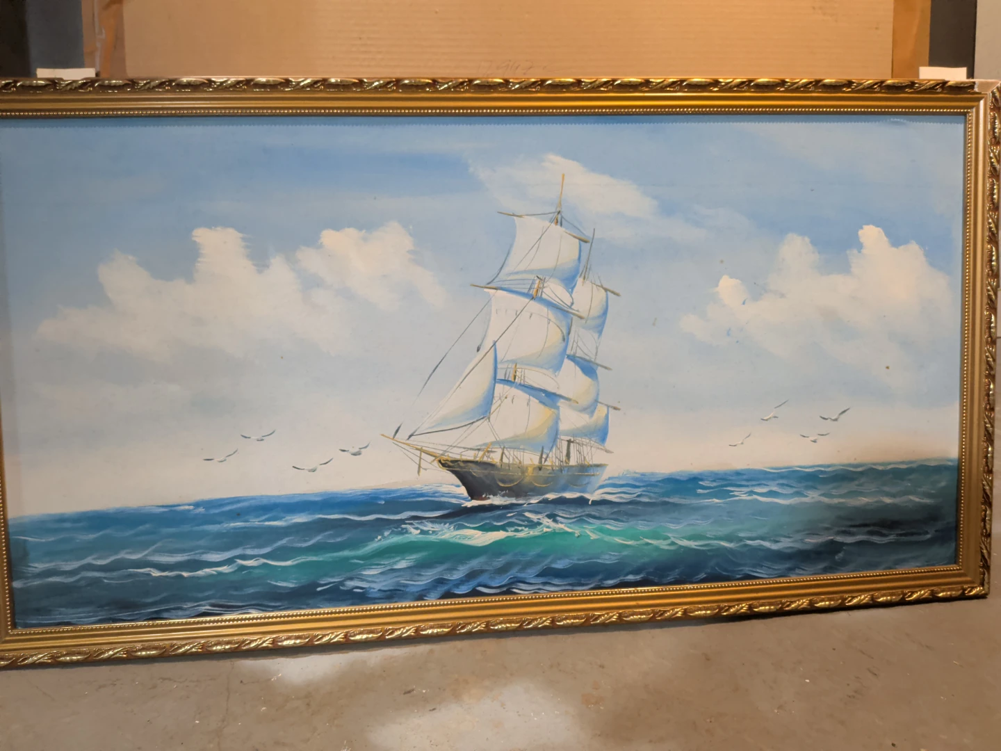 A beautiful framed ship that is an Oil Painting
