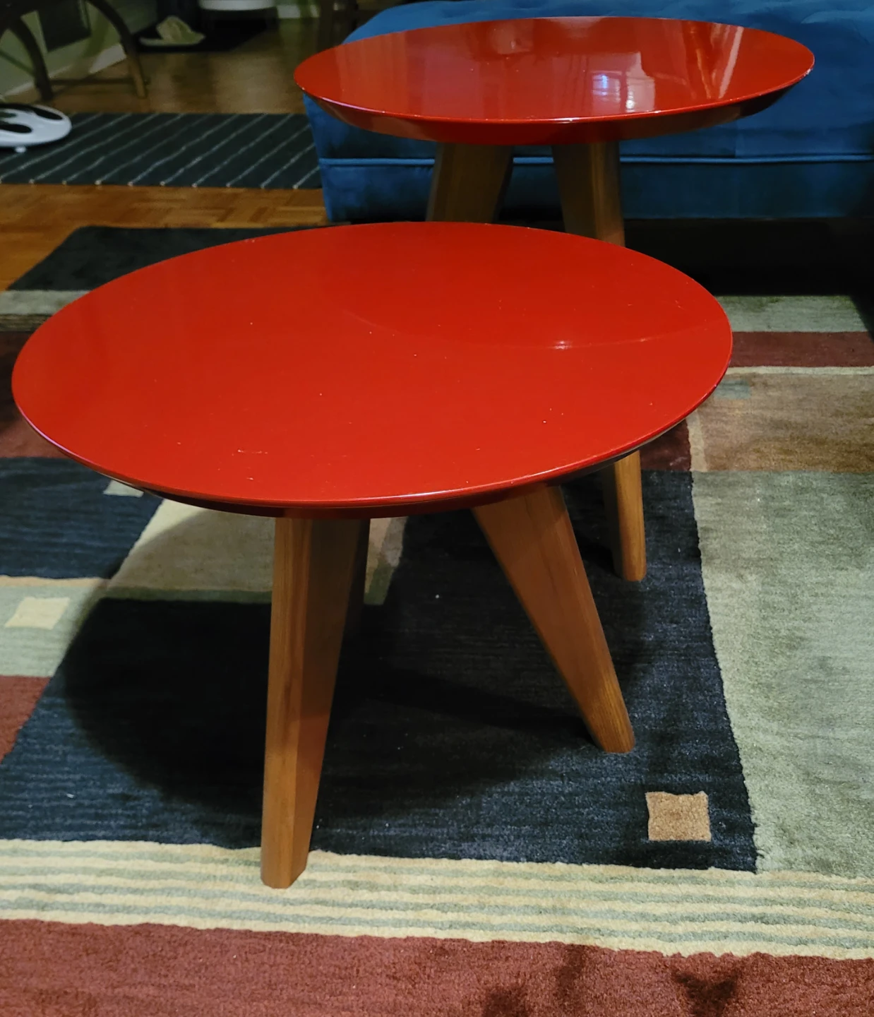 Two red acrylic side tables