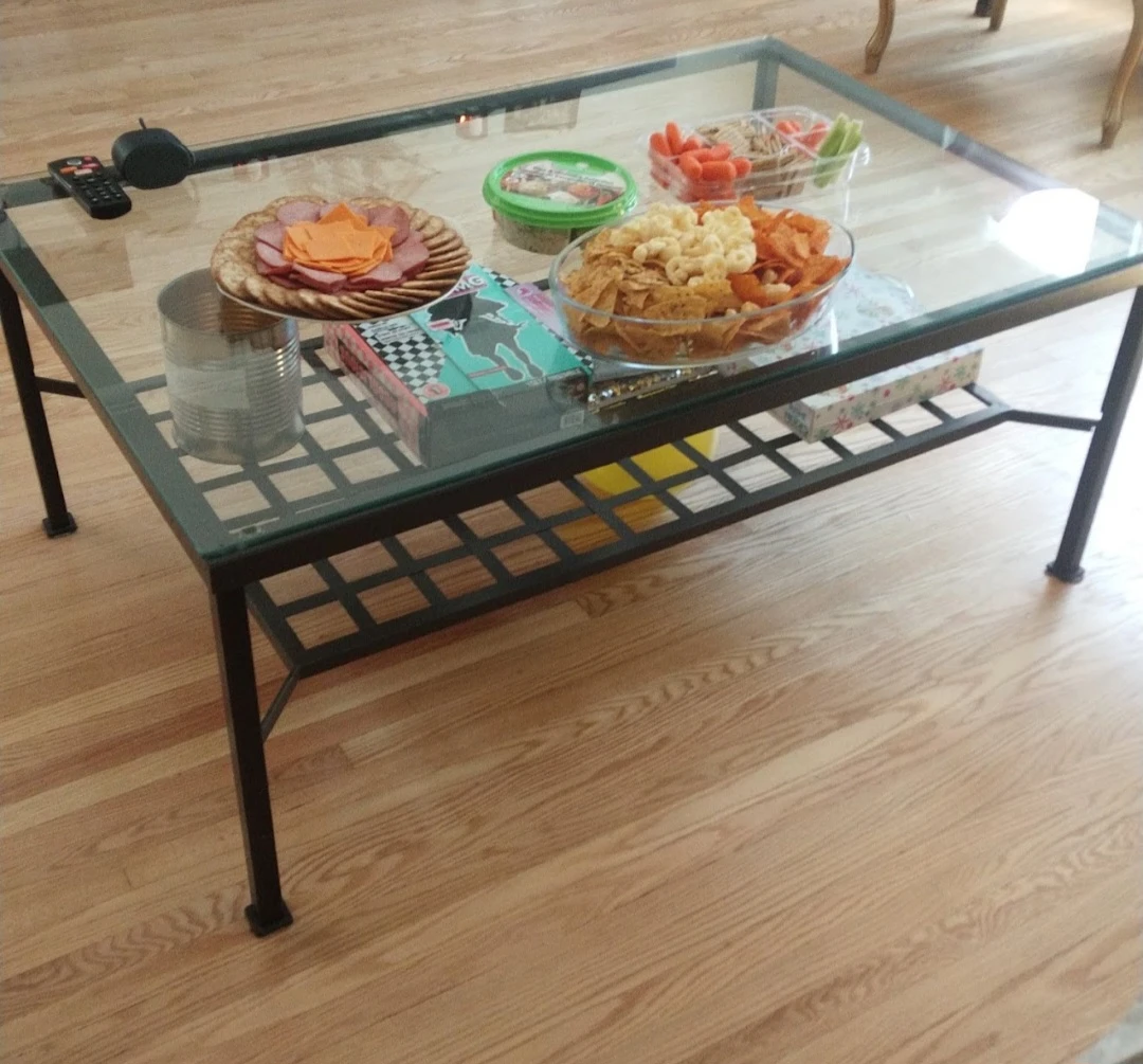 Glass top coffee table with black metal frame