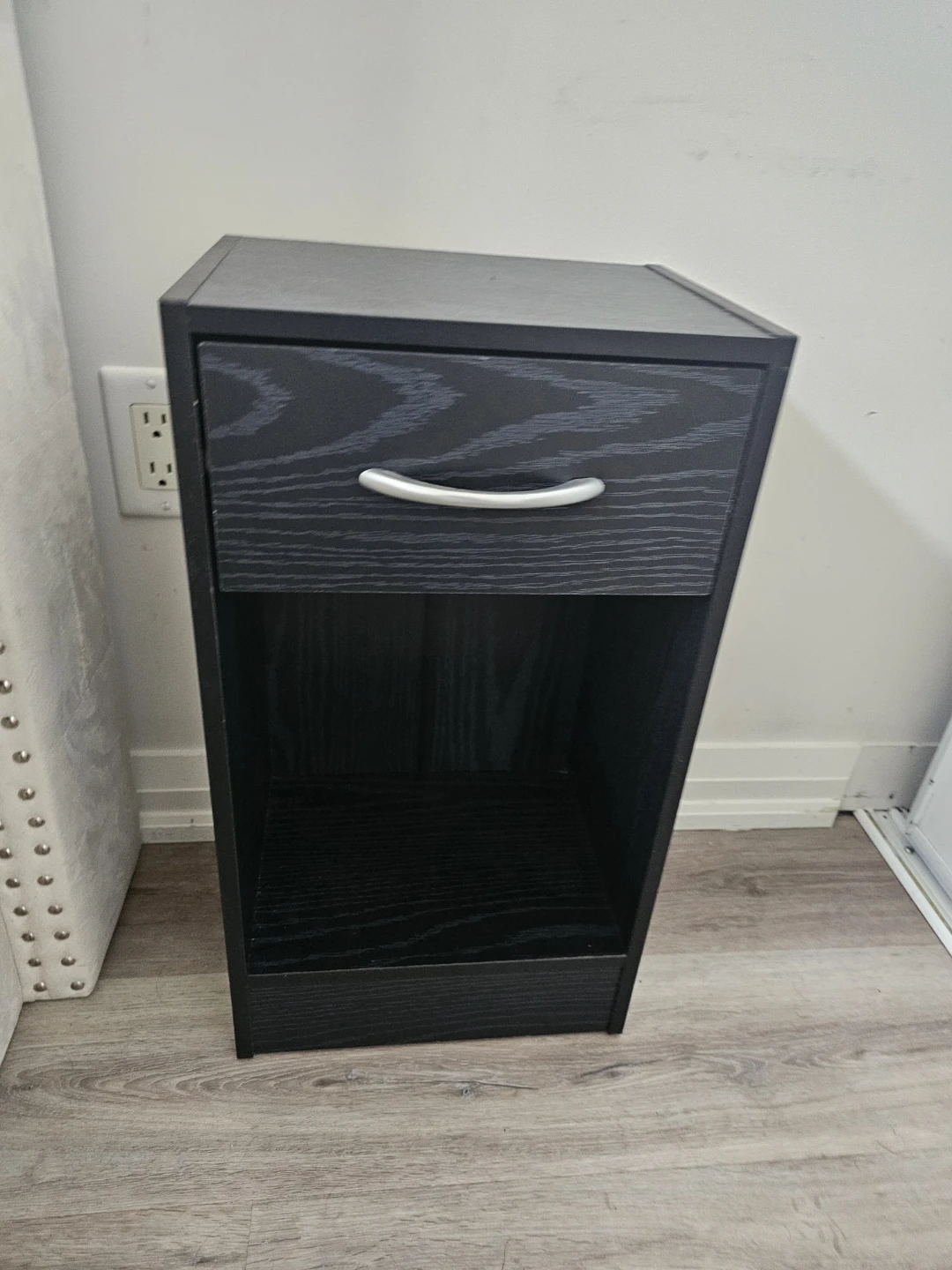 Black wooden nightstand with drawer