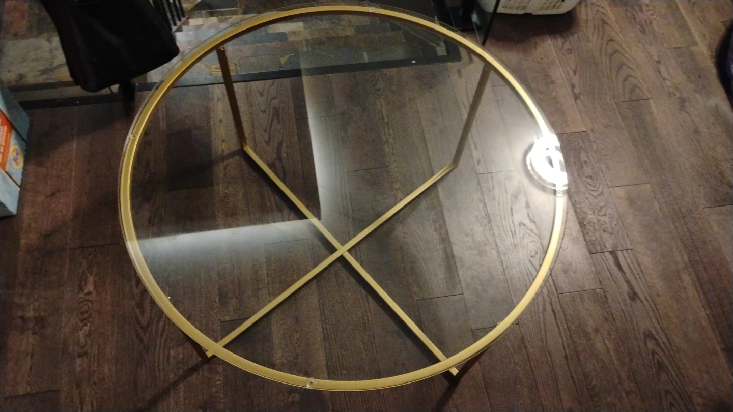 Round glass coffee table with gold frame