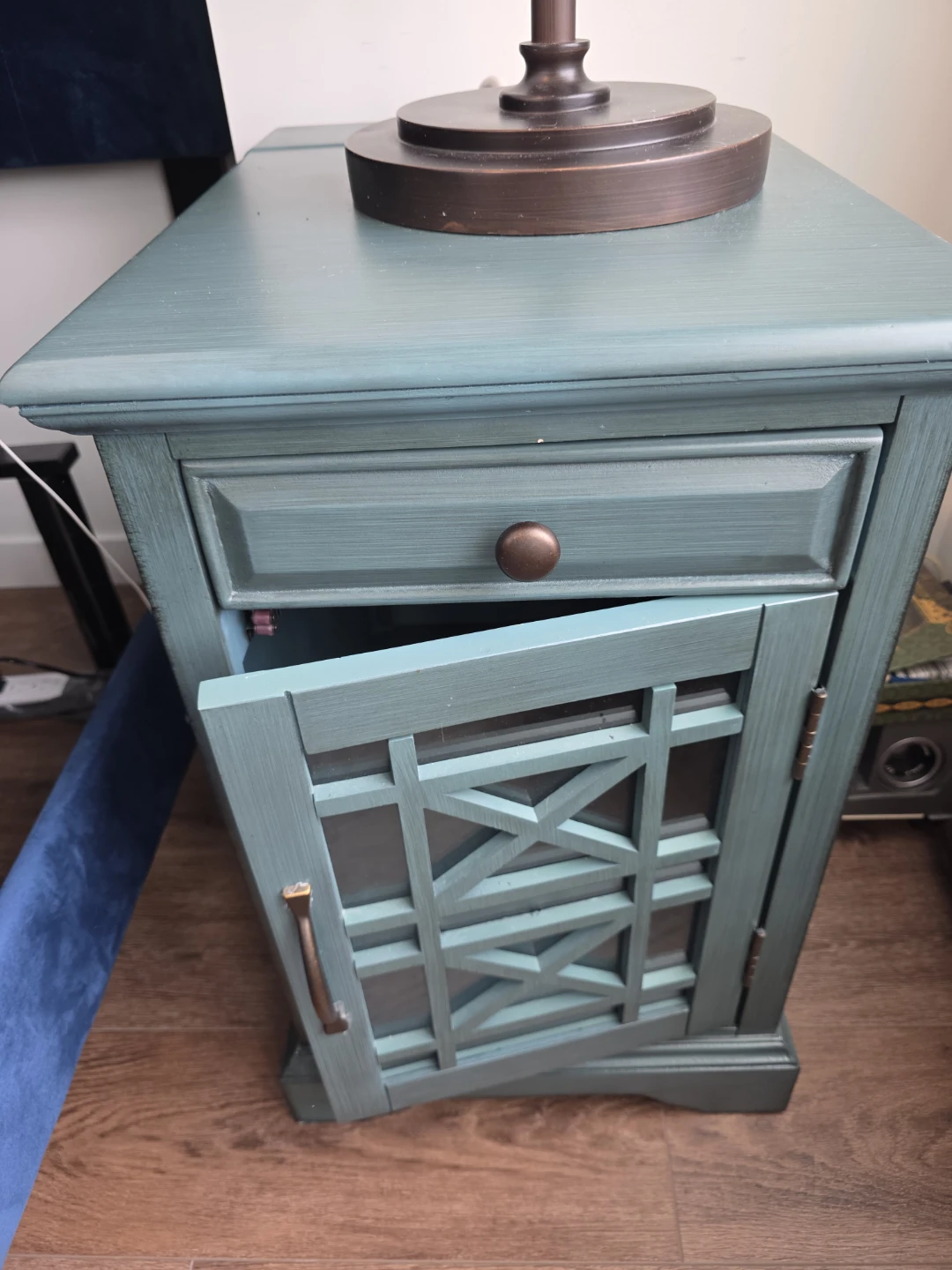 Teal accent nightstand with lattice door