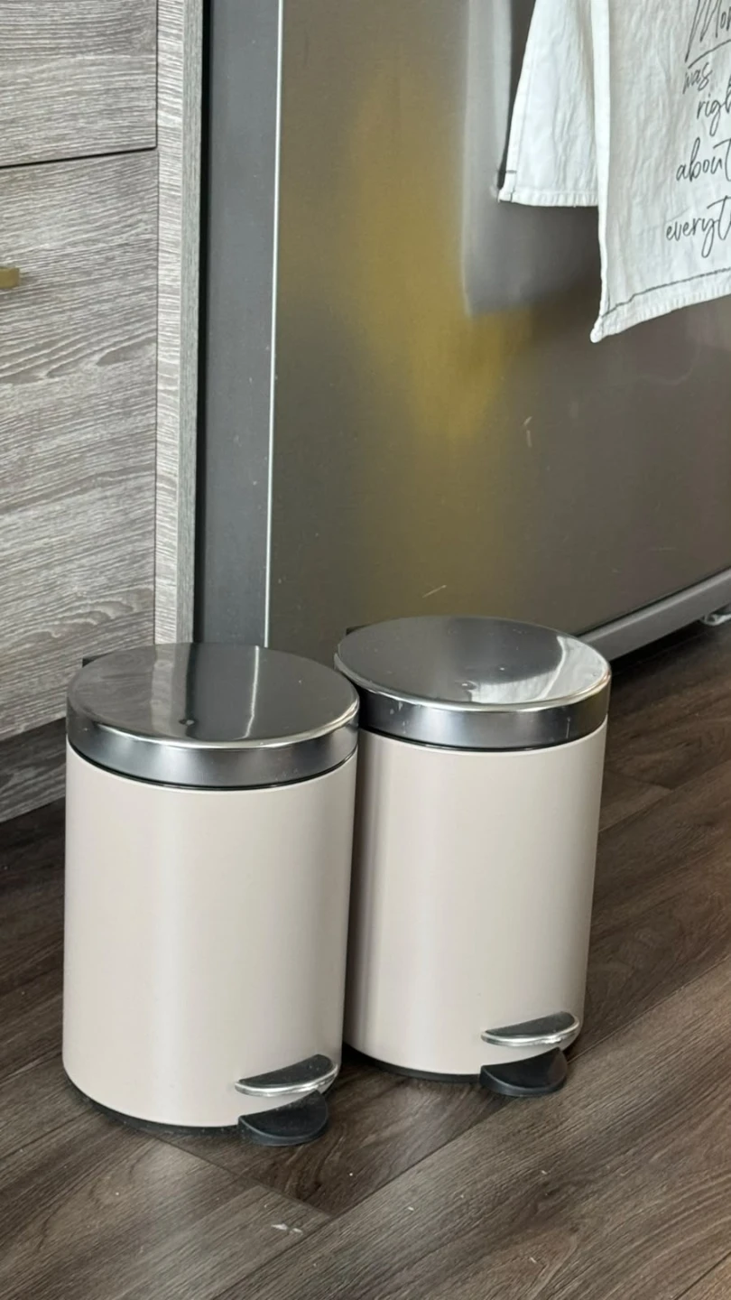 Two cream pedal waste bins