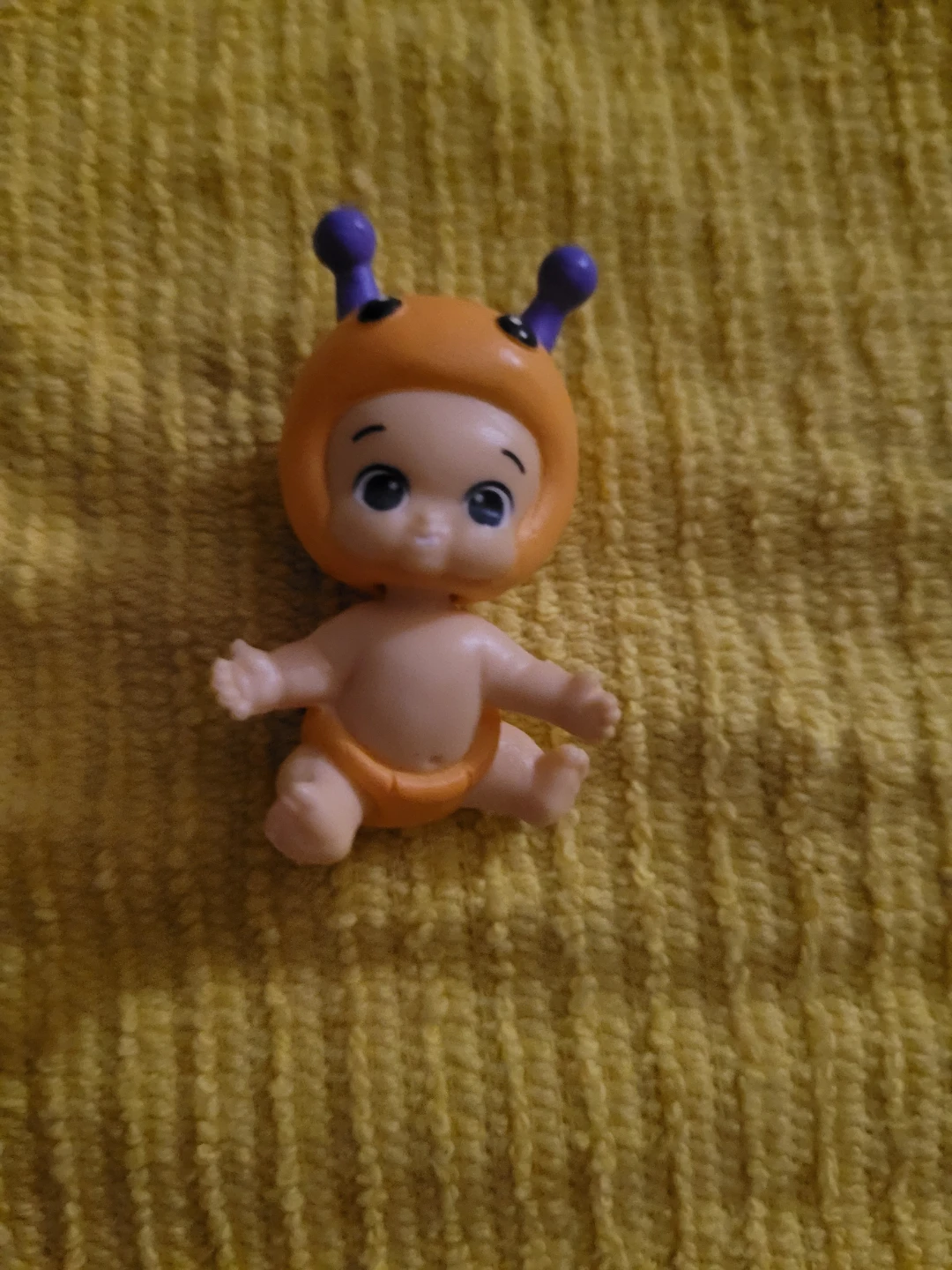 orange-suited bug baby figure