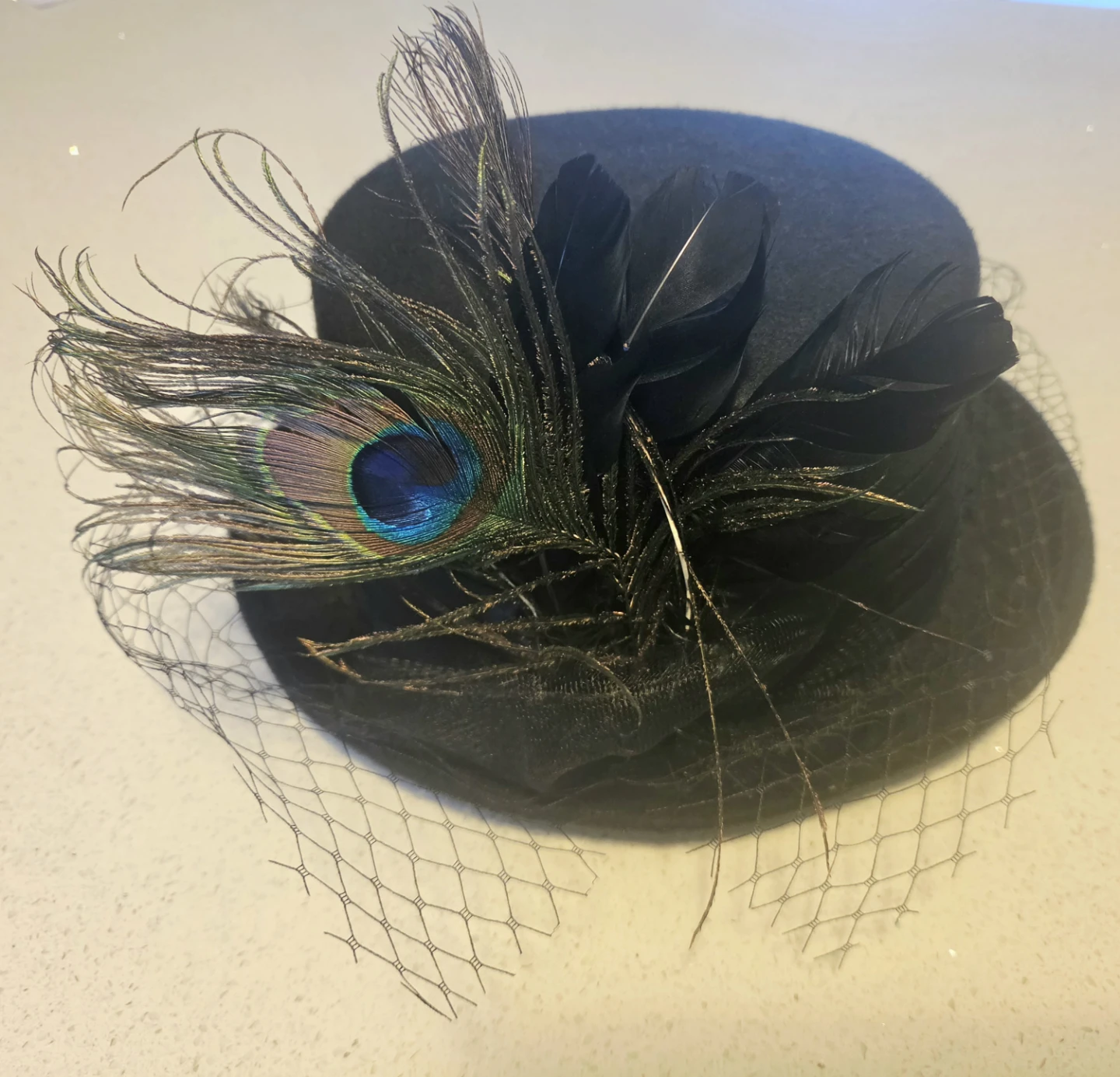Black felt top hat with peacock feathers and veil
