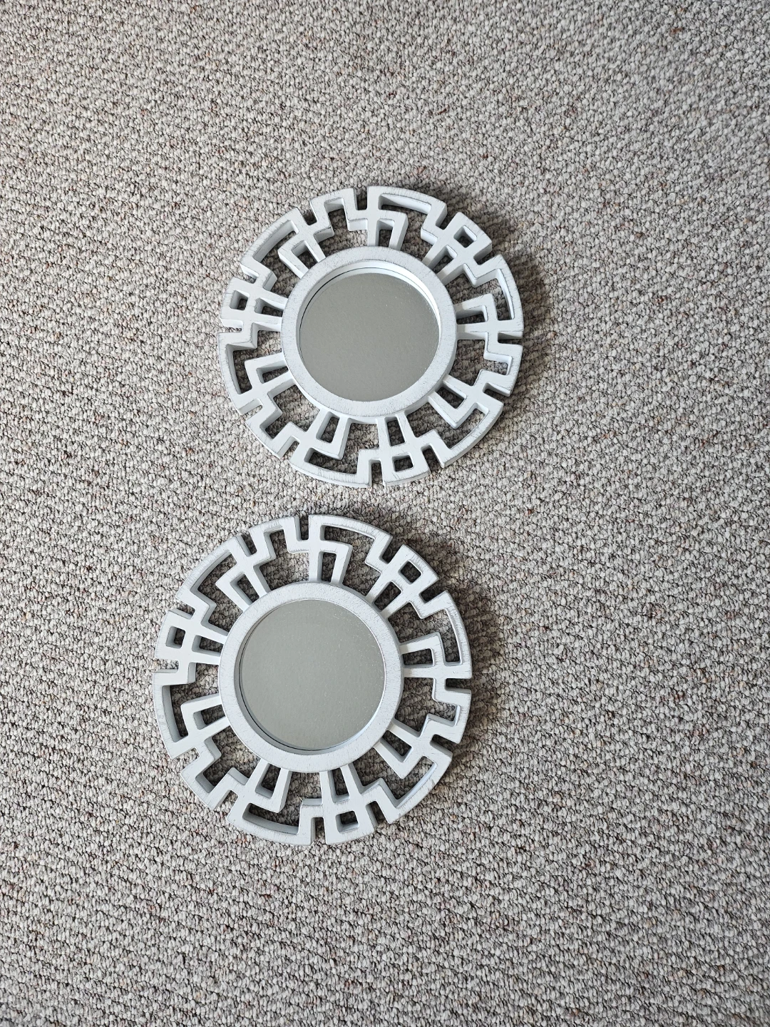 Two decorative white round wall mirrors