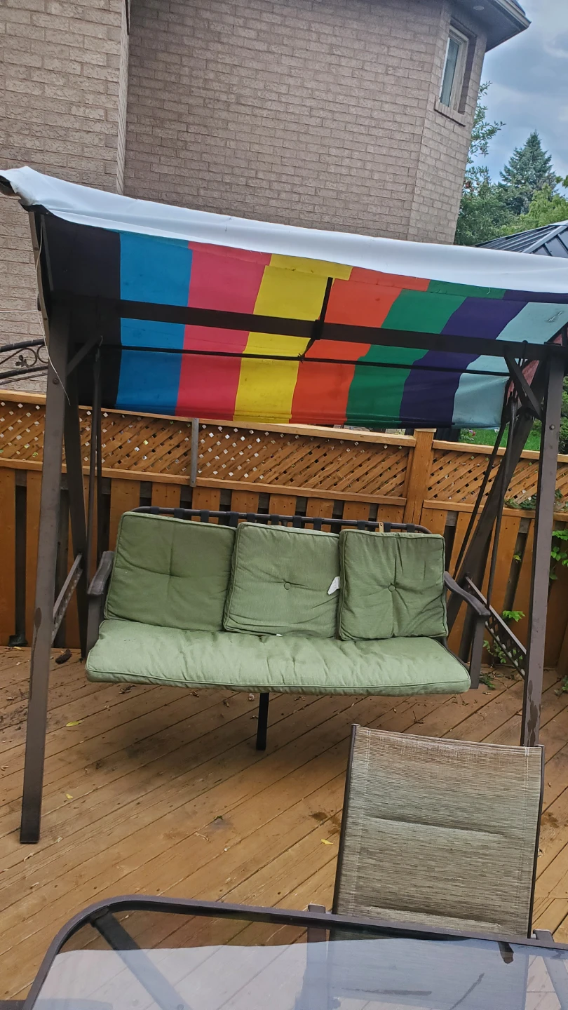 Outdoor patio swing with rainbow canopy